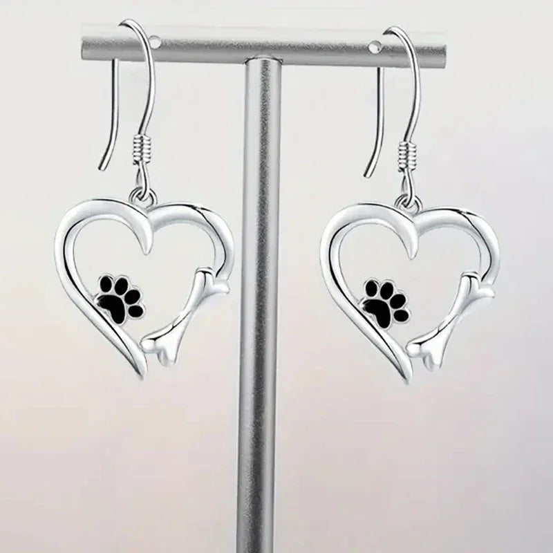 Silver dangling earrings with heart and paw print design